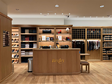 Inside a Bexley store with wooden counter, knitwear, shoes and accessories