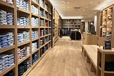 Shelves with folded shirts inside Bexley Valencia store