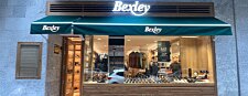 Storefront of Bexley Valencia with green awning