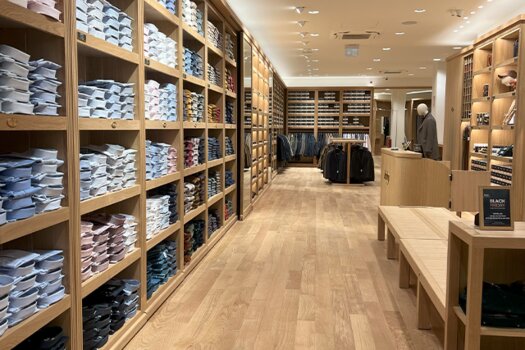 Shelves with folded shirts inside Bexley Valencia store