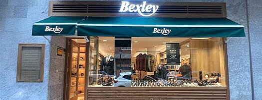 Storefront of Bexley Valencia with green awning 