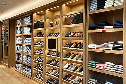 Inside Bexley: wall display with dress shoes, sneakers, and neatly folded shirts.