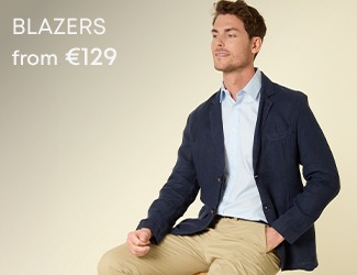 Man wearing a navy blazer with beige trousers