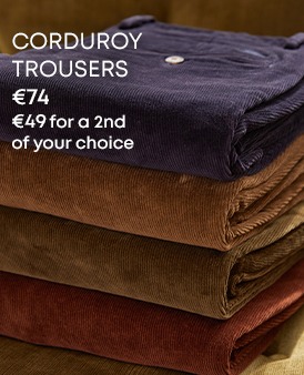 Stack of men’s corduroy trousers in assorted colours