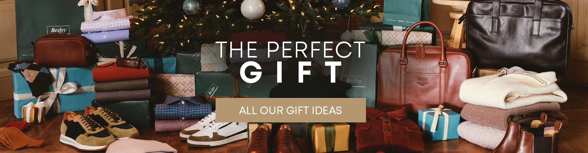 Holiday selection of fashion and accessories: shirts, leather bags, and shoes under the Christmas tree