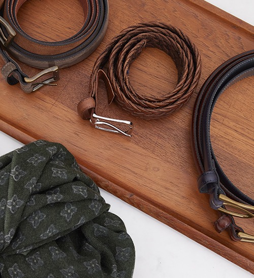Braided leather belts and a patterned wool scarf