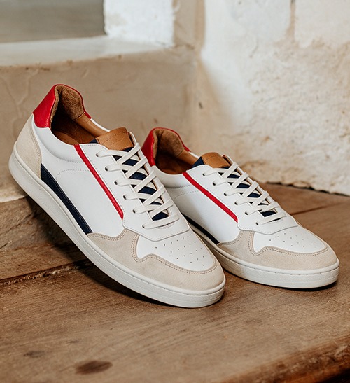 White leather sneakers with navy and red details