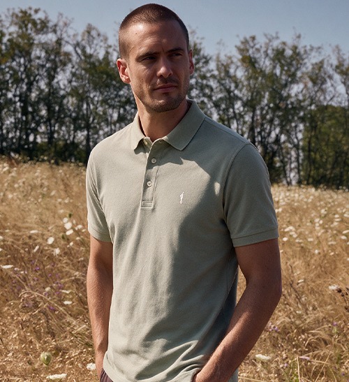 Man wearing a short-sleeved almond green polo shirt