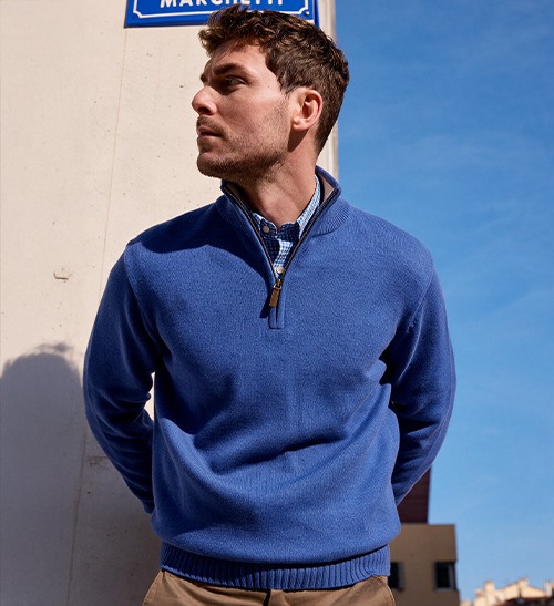 Man wearing a blue zip-neck pullover