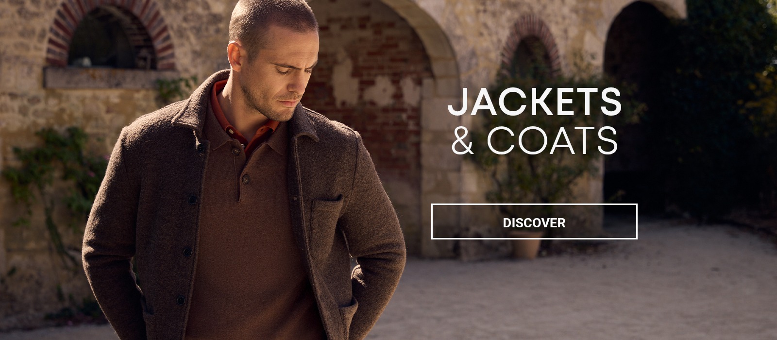 Man wearing a brown jacket over a matching jumper