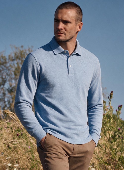 Man wearing a heathered sky blue long-sleeve Alec polo shirt