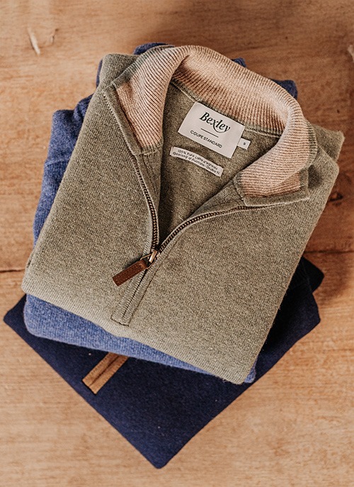Stack of folded Bexley zip-neck pullovers in khaki and navy