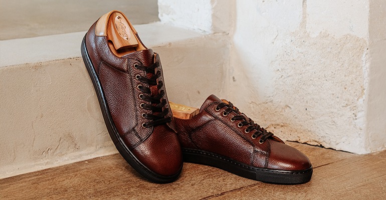 Brown grained leather sneakers with a black sole