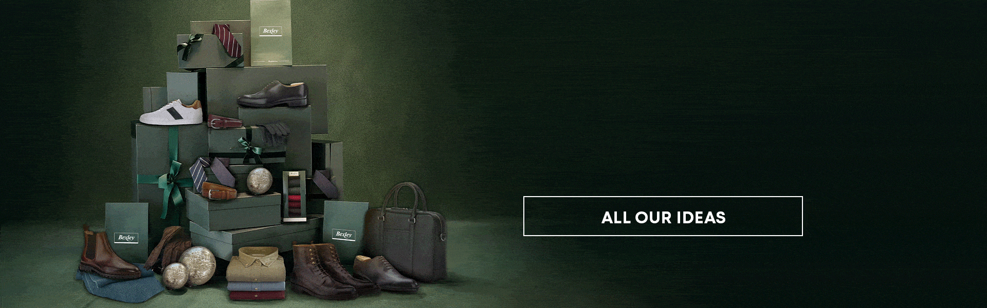 Holiday selection of fashion and accessories: shirts, leather bags, and shoes under the Christmas tree