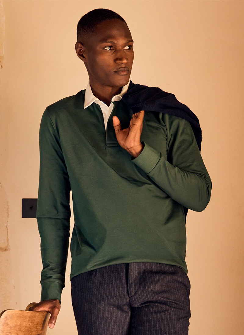 Man wearing a dark green long-sleeve polo shirt