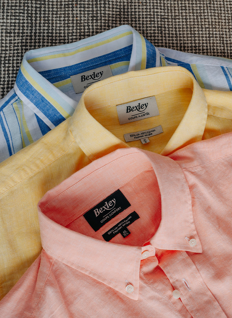 Colourful linen shirts on hangers – -50% offer