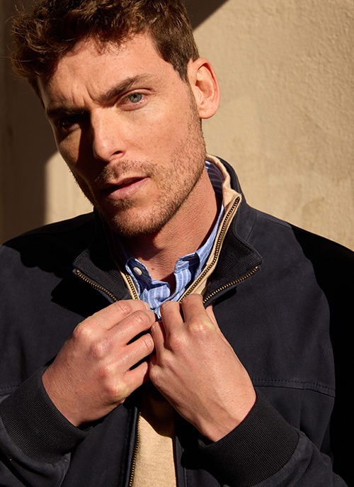 Man wearing a brown suede leather jacket in a smart casual look.