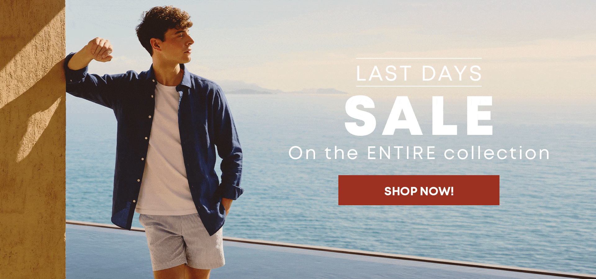 Man wearing a navy linen shirt over a white T-shirt with striped shorts