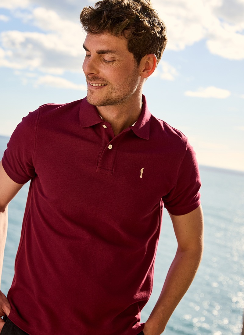 Man in a bordeaux cotton polo shirt