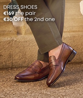 Men's brown leather town loafers worn with khaki trousers