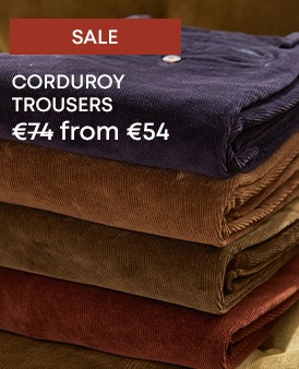 Stack of men’s corduroy trousers in assorted colours
